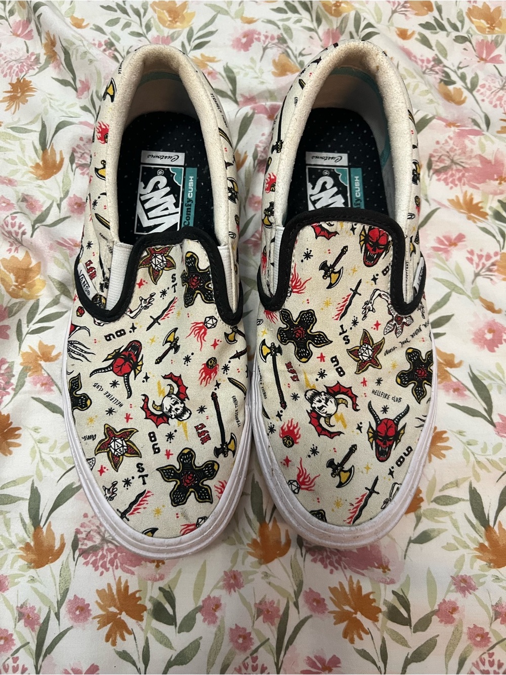 Vans Slip-On Sneakers in Cream with Red, Black & Yellow Tattoo Print